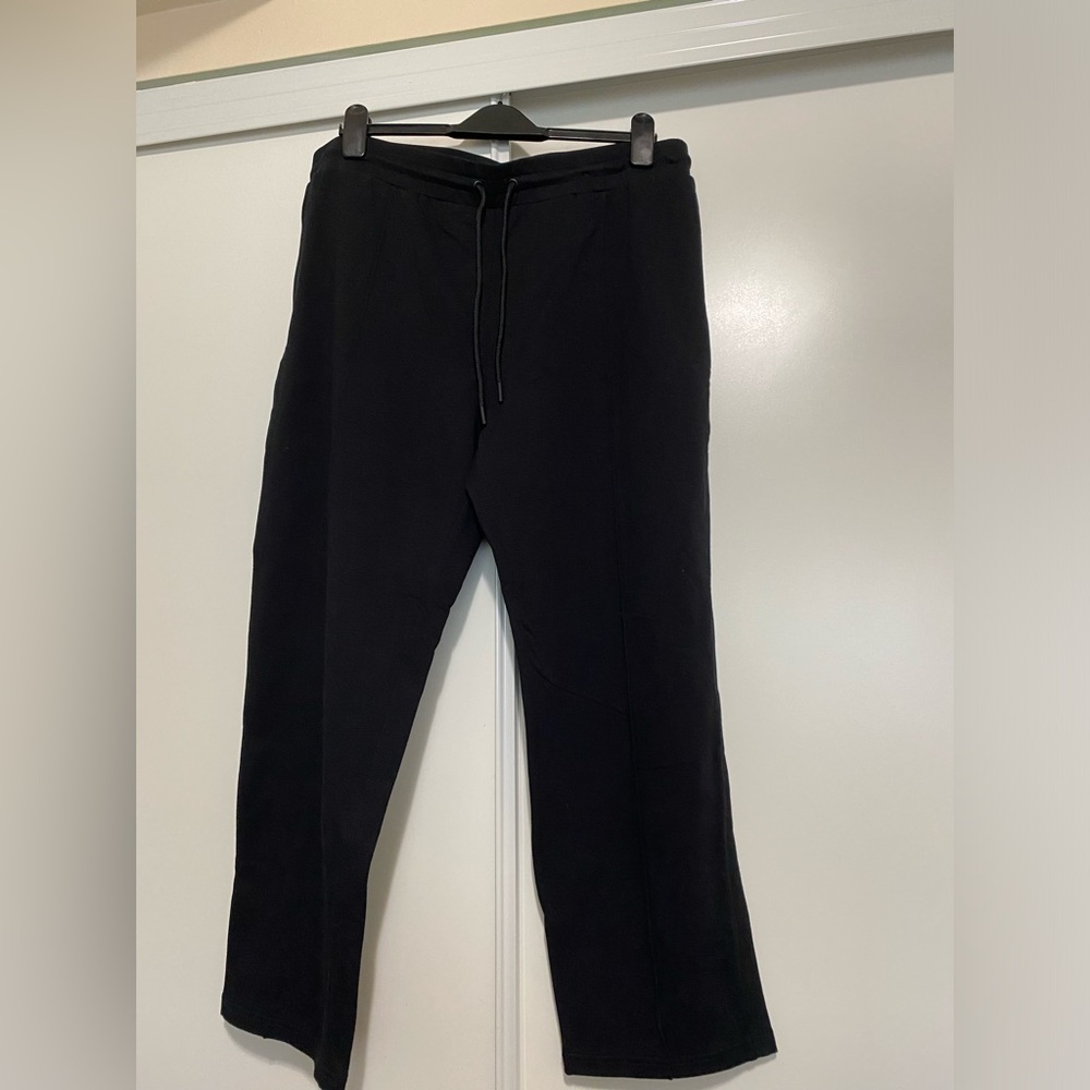 Black pants with drawstrings at the waist.